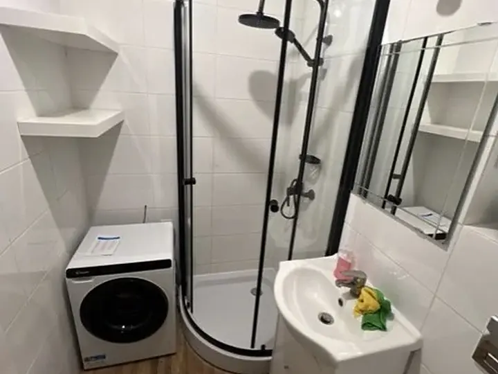 Mała łazienka z półokrągłą kabiną i pralką — DobryHydraulik Bydgoszcz